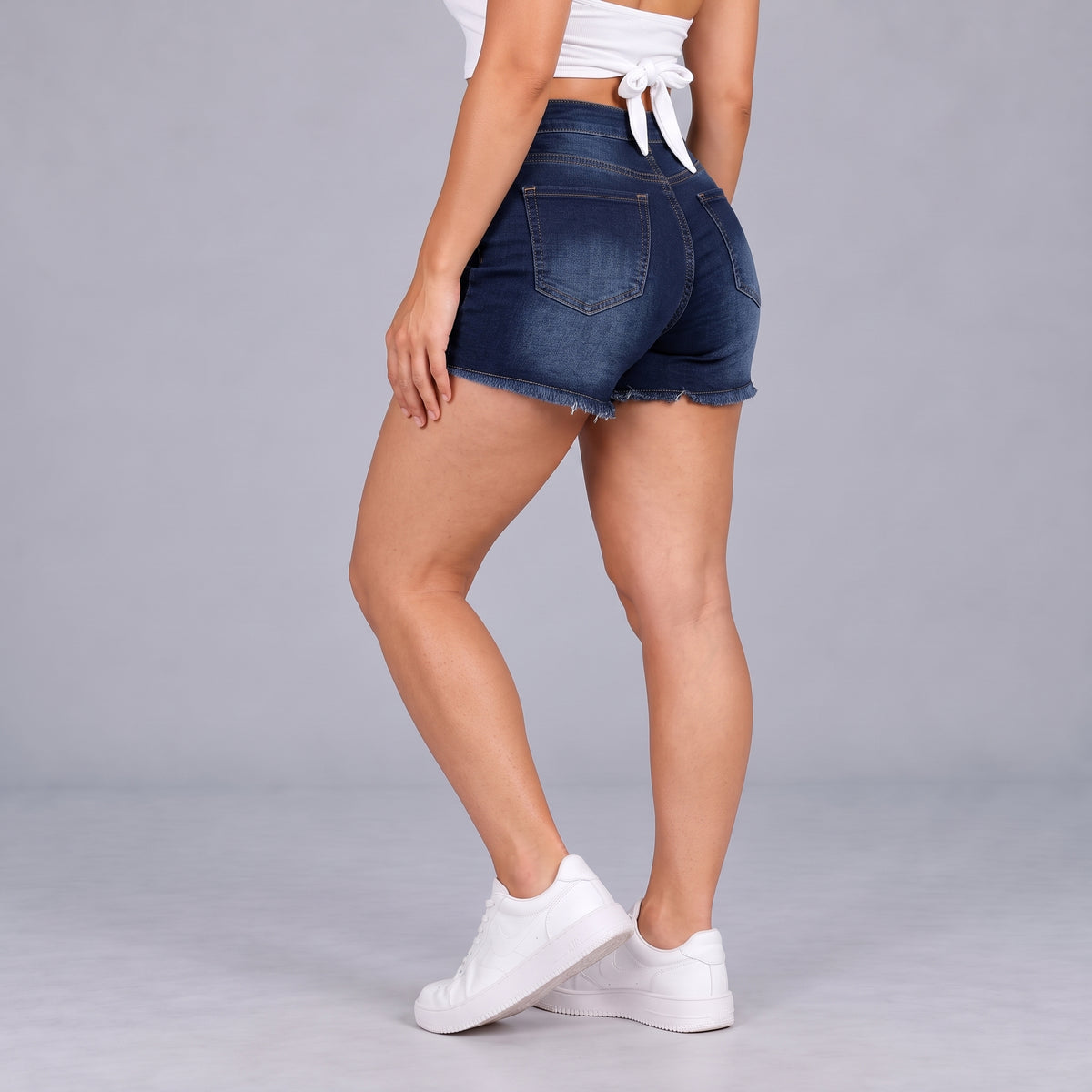 Sculpt Denim Shorts in dark blue, side view walking