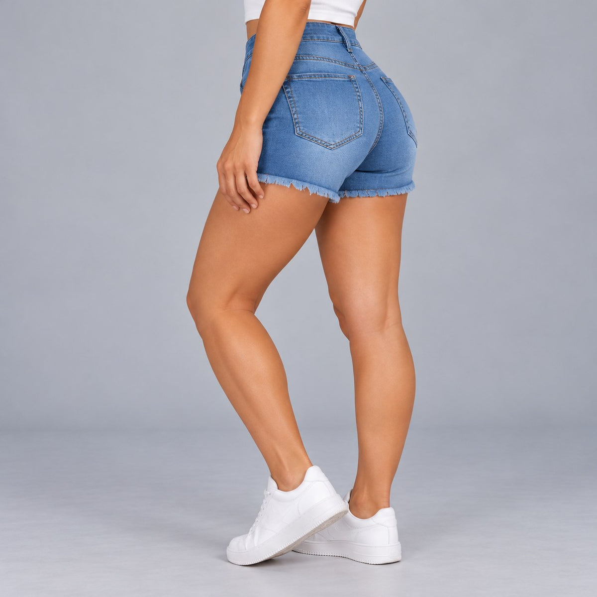 Sculpt Denim Shorts in mid blue, side view walking