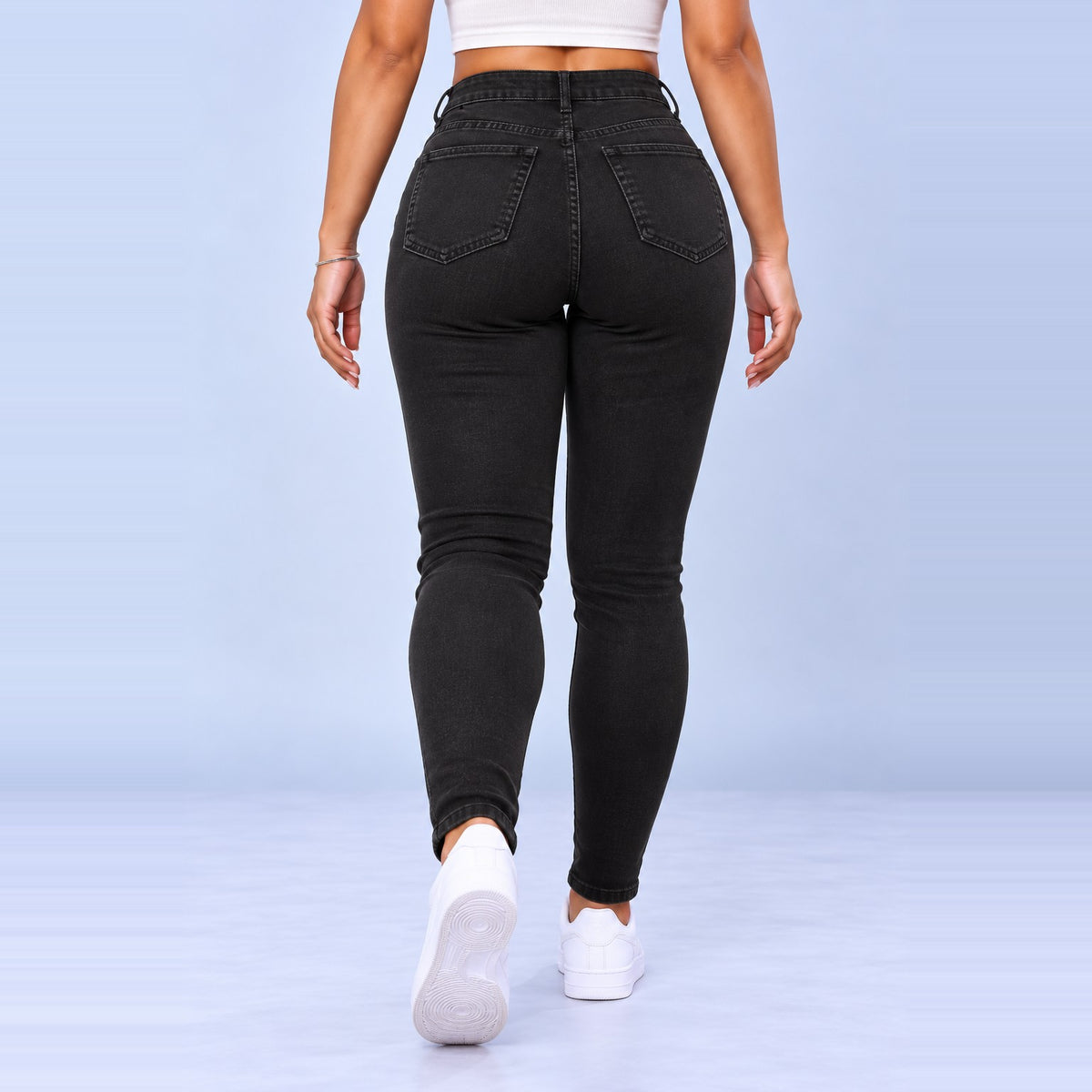 Sculpt Skinny BBL jean in black, walking back view