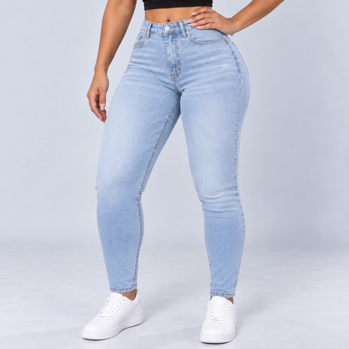 Sculpt Skinny BBL jean in light blue, front view, hand on hip