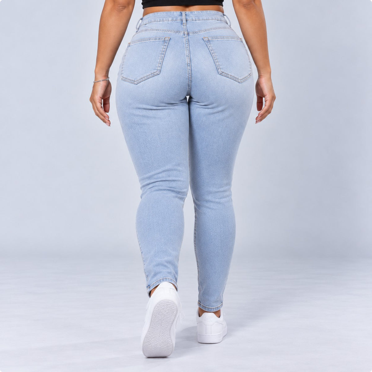 Sculpt Skinny BBL jean in light blue, walking back view